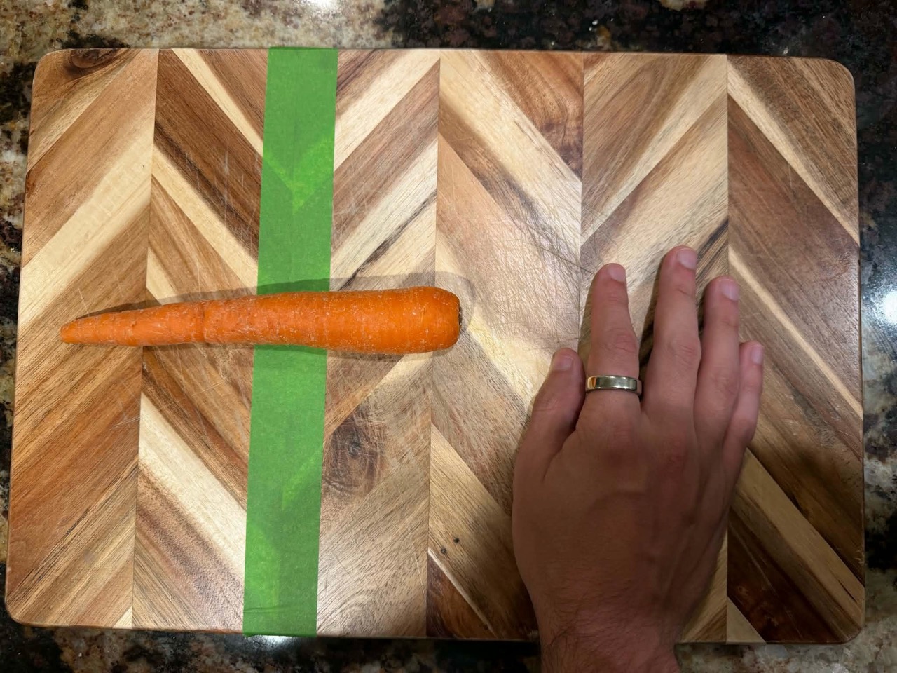 Hand on the right, clear of the carrot and green tape